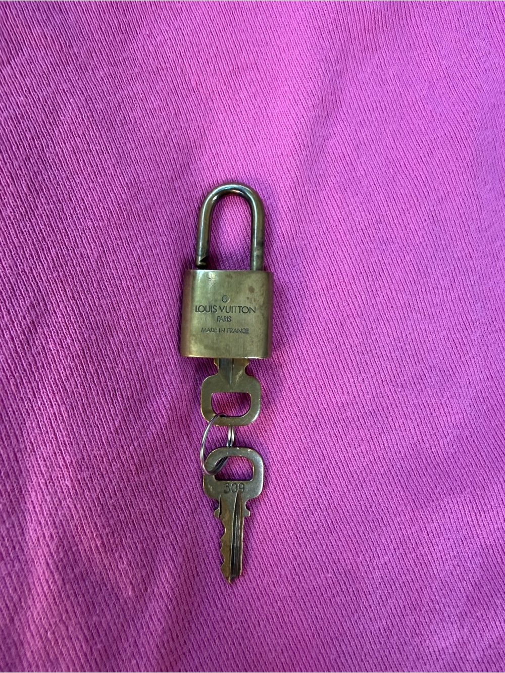 Louis Vuitton Brass Padlock and Key on Pink Background - Picture 2 of 2